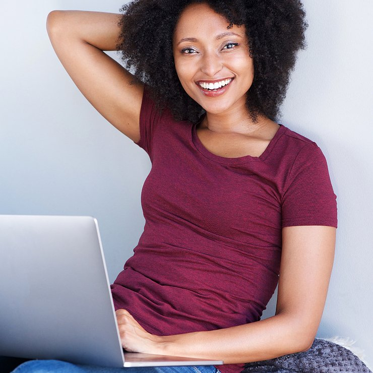 Smiling woman with laptop